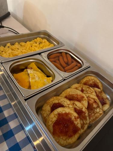 four trays of pastries and other food on a table at Apartmány Tri sestry Jasná in Demanovska Dolina