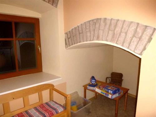 a room with a bed and a table and a window at Ferienwohnungen Manuela in Schottwien