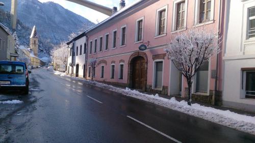 a snow covered street in a town with buildings at Ferienwohnungen Manuela in Schottwien