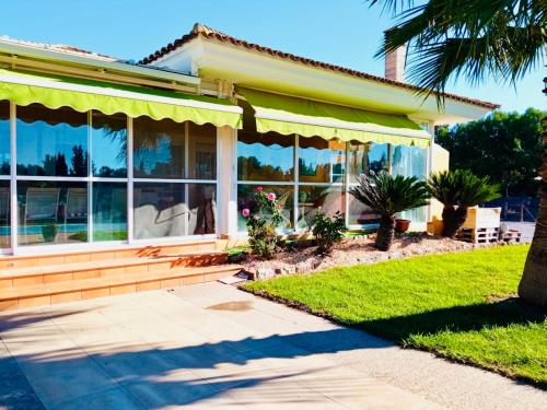 a house with large windows and a porch at Chalet La Calma en Lorca in Lorca