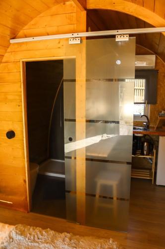 a kitchen with a stainless steel appliance in a room at Óbidos Wood Villas in Olho Marinho