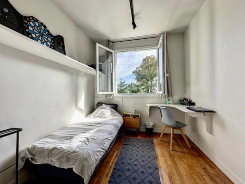 Schlafzimmer mit einem Bett, einem Schreibtisch und einem Fenster in der Unterkunft La Pelletière in Garches