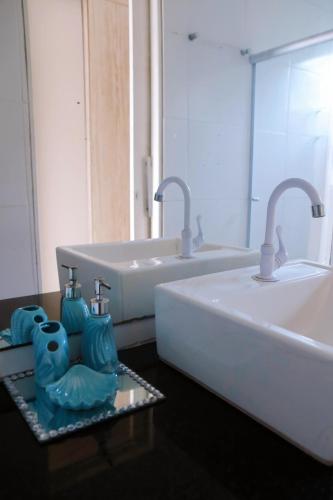 a bathroom with a sink and two faucets at Casa Mares do Sul in Marechal Deodoro
