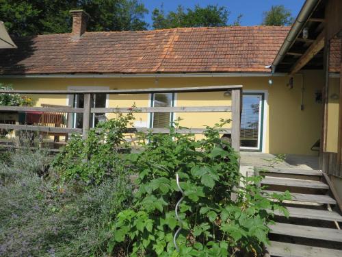 a small house with a porch and a fence at Ferienhaus Baumgarten1 in Gnas