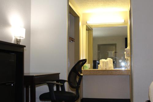 a mirror in a hotel room with a desk and a chair at Days Inn by Wyndham Wrightstown McGuire AFB Bordentown in Wrightstown