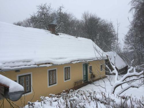 a house with snow on the top of it at Ferienhaus Baumgarten1 in Gnas
