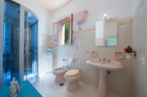 a bathroom with a toilet and a sink and a shower at Elegant house overlooking the sea, easy park, wifi in Praiano