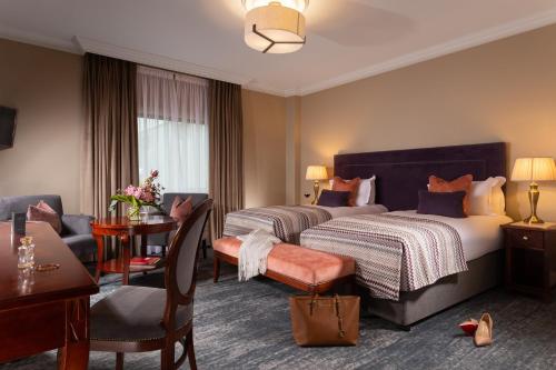 a hotel room with two beds and a desk at The Heritage in Killenard
