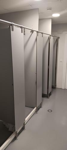 a row of stalls in an empty room at Albergue Santiago Apostol in Logroño