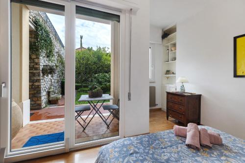 a bedroom with a sliding glass door leading to a patio at Il giardino di Giò in Finale Ligure