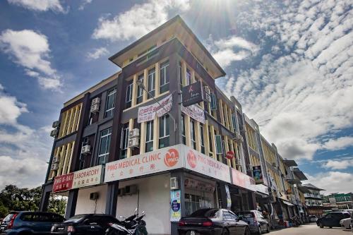 a building on a street with cars parked in front of it at OYO 90094 Hi Inn 3 in Sibu