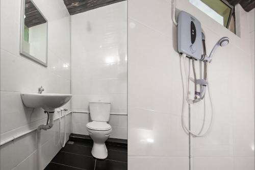 a bathroom with a toilet and a sink at OYO 90094 Hi Inn 3 in Sibu