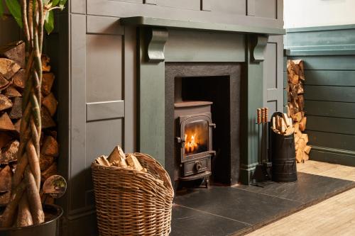 a fireplace in a living room with a fire place at Rashleigh Arms in St Austell