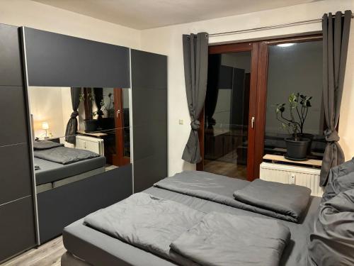 a bedroom with two beds and a mirror at Henriette 2 in Walkenried