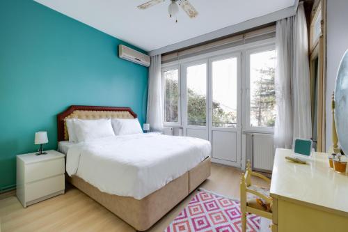 a bedroom with a bed and a blue wall at Sea View Retreat in Buyukada 1 min to Ferry in Istanbul