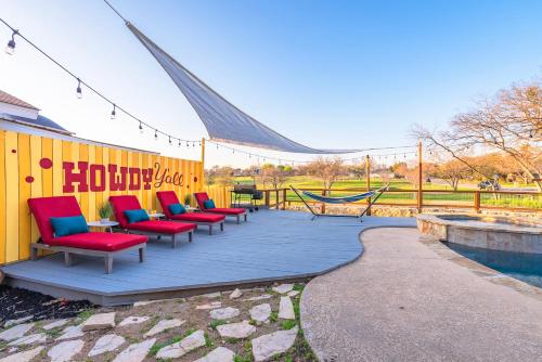 a group of chairs sitting on a deck next to a pool at Stunning Pool Overlooking Golf Course & Game Room in San Antonio