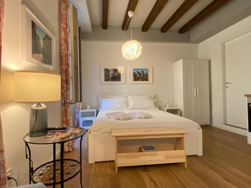 a bedroom with a bed with a table and a lamp at Wish Rooms Charme&Relax in Bergamo