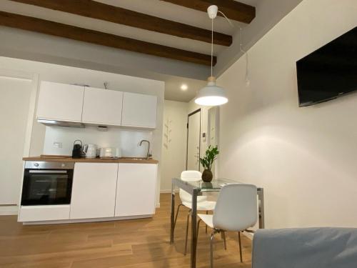 a kitchen and dining room with a table and chairs at Wish Rooms Charme&Relax in Bergamo