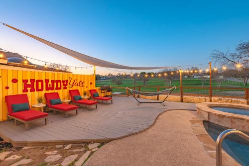 a deck with chairs and a hammock next to a pool at Stunning Pool Overlooking Golf Course & Game Room in San Antonio