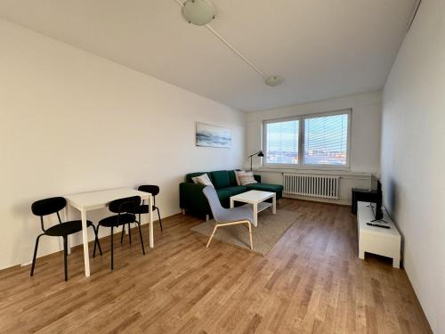 a living room with a green couch and a table at Ubytování Velešín in Velešín
