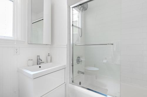 a white bathroom with a sink and a shower at Marina District 2BR w WD nr Parks Presidio SFO-434 in San Francisco