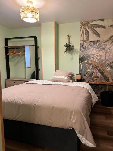 une chambre avec un lit et un grand miroir dans l'établissement Gîte du Marcotton, à Arbois