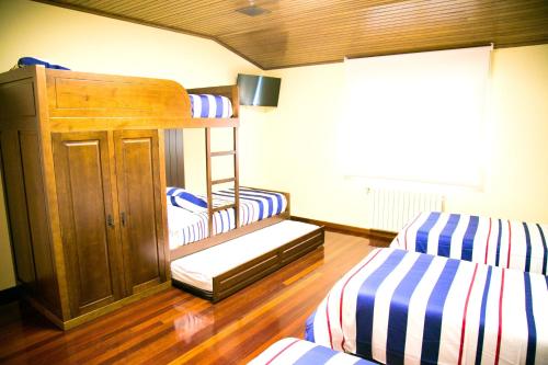 a room with two bunk beds and a ladder at 4 bedrooms house with private pool jacuzzi and enclosed garden at Magan in Cuntis