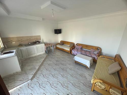 a living room with two couches and a tv at Summer Rental in Nabeul