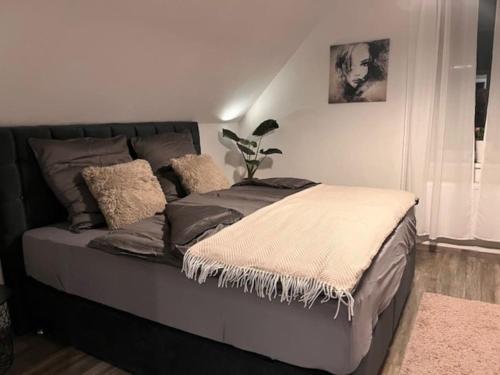 a bed in a bedroom with a plant on it at Apartment Am Stadtwald in Werne an der Lippe / NRW in Werne an der Lippe
