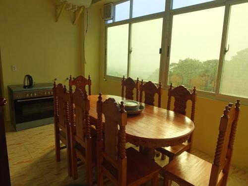 a dining room with a wooden table and chairs at YahVilla Homestay in Baguio