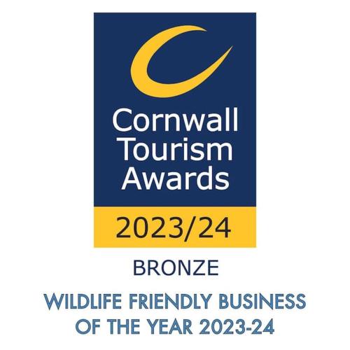 a sign for the council tourism awards with a yellow c on it at Clotted Cream -Lydcott Glamping, Cornish Sea Views in Looe