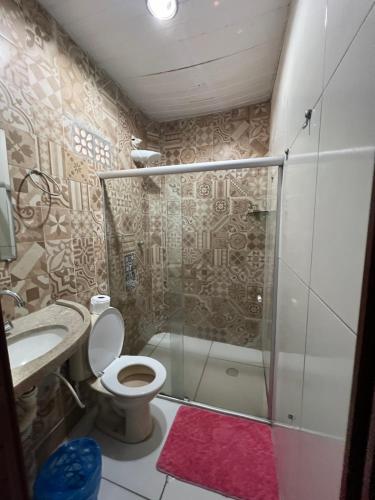 a bathroom with a shower and a toilet and a sink at Ladeira de Olinda in Olinda