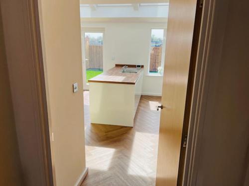 a kitchen with a counter and a sink in a room at Cheshire East Detached 3BD, Central home CW1 in Crewe