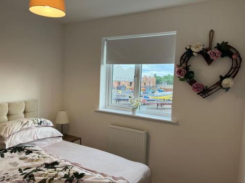 a bedroom with a heart shaped window and a bed at Cheshire East Detached 3BD, Central home CW1 in Crewe