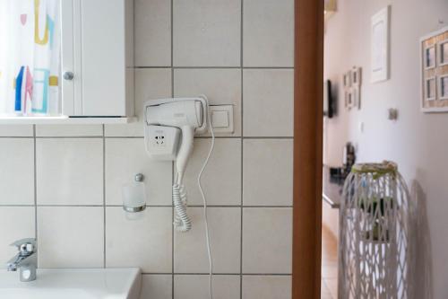 a bathroom with a hair dryer on a wall at Belleza Villa in Lixouri