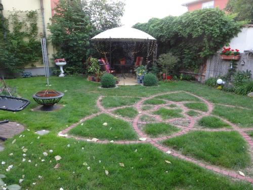a garden with a peace sign in the grass at Ferienwohnungen Haus Leonore in Stendal