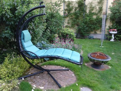 a black and blue chair in a yard at Ferienwohnungen Haus Leonore in Stendal