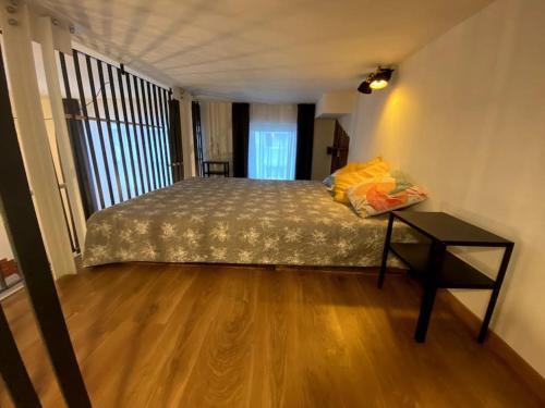a bedroom with a bed and a table in it at Kramare 303 in Bratislava