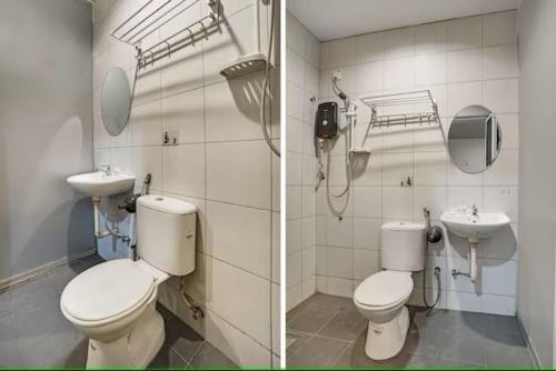a bathroom with two toilets and a sink at Hotel Ventura in Kangar
