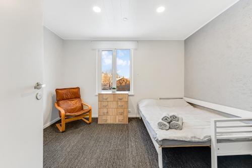 a bedroom with a bed and a chair and a window at Juhkentali 46, korter 6 in Tallinn