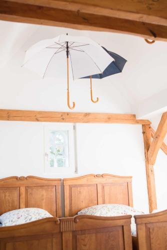 two umbrellas hanging from the ceiling of a room at Haus am Holder in Böhme