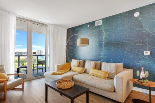 a living room with a white couch and a blue wall at Spectacular Balcony - Near Beach - Gym - Pool in Hallandale Beach