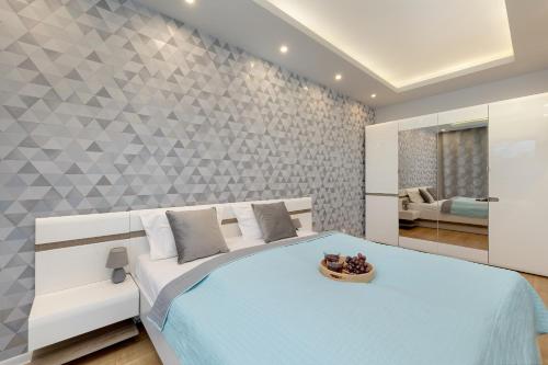 a bedroom with a bed with a bowl of fruit on it at Porta Mare - Apartment with Sea View Balcony & Parking by Renters in Dziwnówek