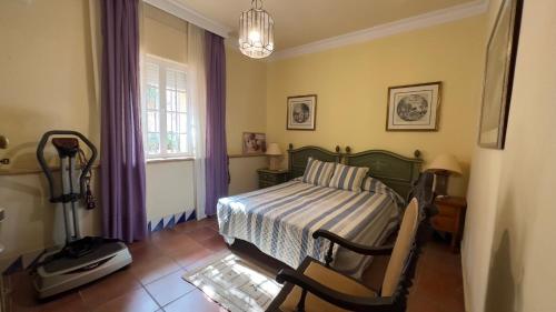 1 dormitorio con 1 cama, 1 silla y 1 ventana en VILLA BELLAVISTA en Ceuta