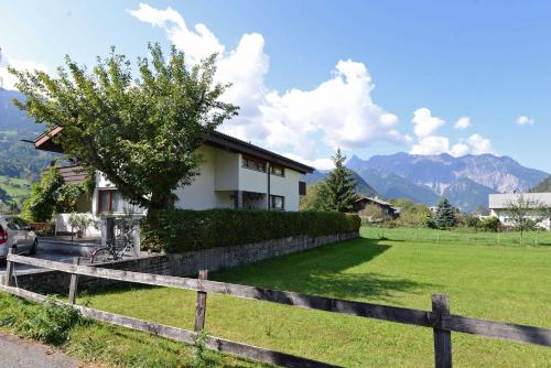 a house with a fence in front of a field at Haus Sonnblick in Schruns