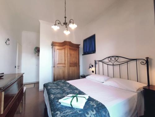 a bedroom with a large white bed with a wooden headboard at Casa Fasano Amalfi Coast in Vietri