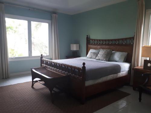 a bedroom with a large bed and a window at Coral Harbour Beach Apartment in Nassau