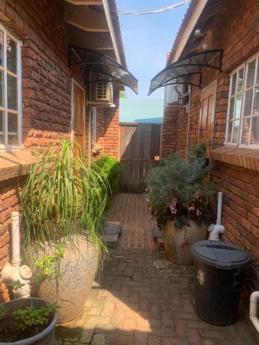 a patio with plants and a brick house at MAM in Mokopane