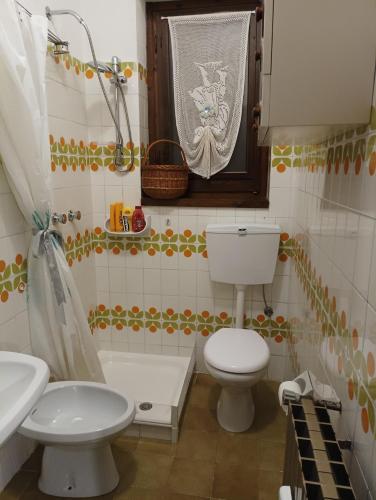 a bathroom with a toilet and a sink at Tosa Inn in Miroglio
