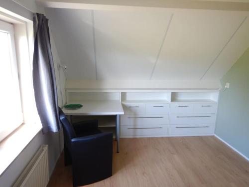 a room with a desk and a chair next to a window at Villa Schelphoek - ein toller Ort zum Entspannen in Wolphaartsdijk